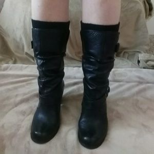Black Aldo boots mid-calve height.